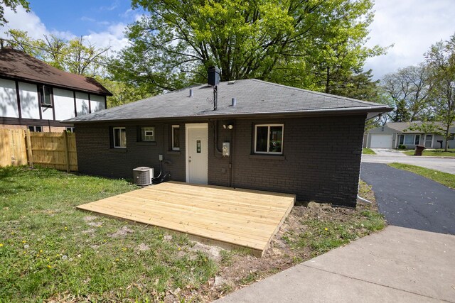 239 Marquette St, Park Forest, IL 60466 - back of property featuring a wooden deck, brick siding, and central AC unit
