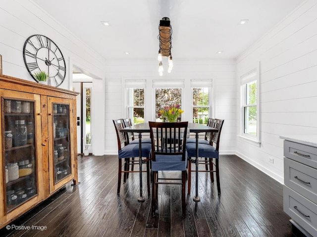 733 S Naperville Rd, Wheaton, IL 60189 - dining space with ornamental molding, dark wood-style flooring, baseboards, and wooden walls