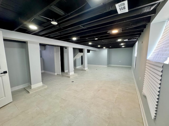 below grade area featuring stairway and baseboards