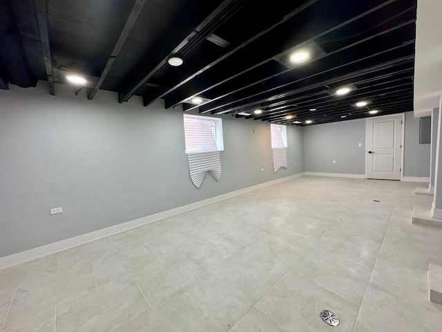 below grade area with light tile patterned floors and baseboards