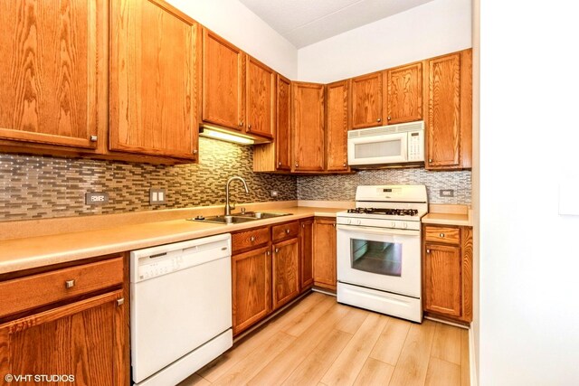 9355 W Irving Park Rd Unit 120, Schiller Park, IL 60176 - kitchen with white appliances, a sink, light wood finished floors, decorative backsplash, and light countertops