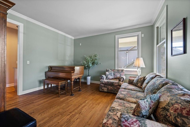 living room with wood finished floors, crown molding, and baseboards
