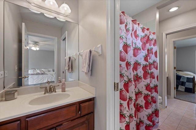 ensuite bathroom with tile patterned flooring, vanity, ceiling fan, and a shower with curtain