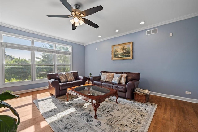 living room featuring crown molding, ceiling fan, baseboards, wood finished floors, and recessed lighting