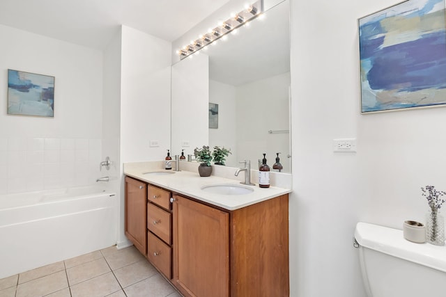 bathroom featuring tile patterned floors, toilet, a garden tub, and double vanity