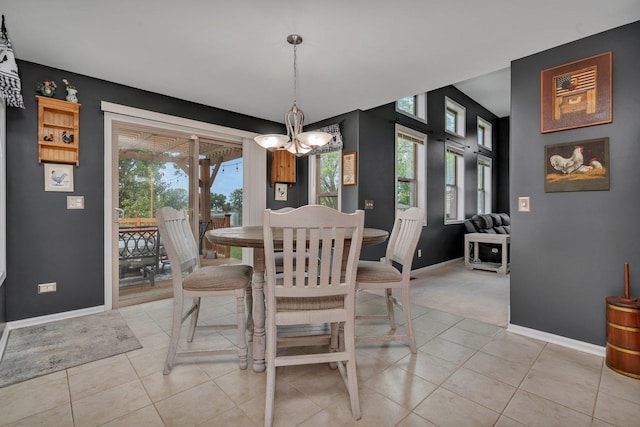 203 Jefferson St, Manteno, IL 60950 - dining space featuring baseboards, light tile patterned floors, a chandelier, and light carpet