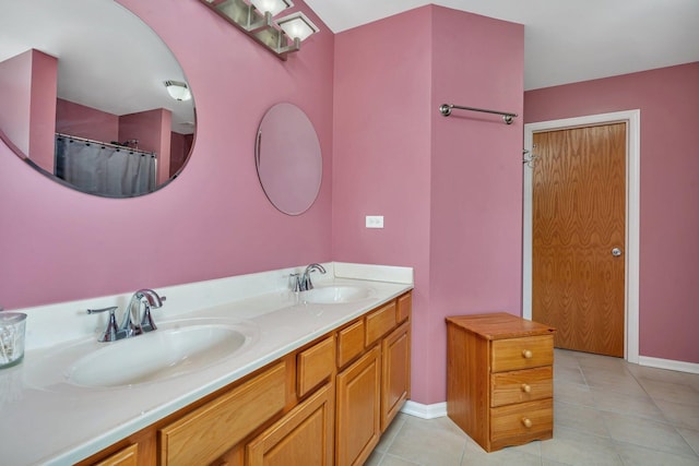 203 Jefferson St, Manteno, IL 60950 - bathroom featuring double vanity, tile patterned flooring, and baseboards