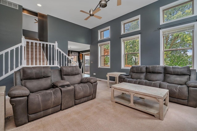 203 Jefferson St, Manteno, IL 60950 - carpeted living room featuring a ceiling fan, stairs, a towering ceiling, baseboards, and recessed lighting