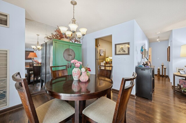 70 W Huron St Unit 708, Chicago, IL 60654 - dining room featuring a chandelier, dark wood-style floors, and baseboards