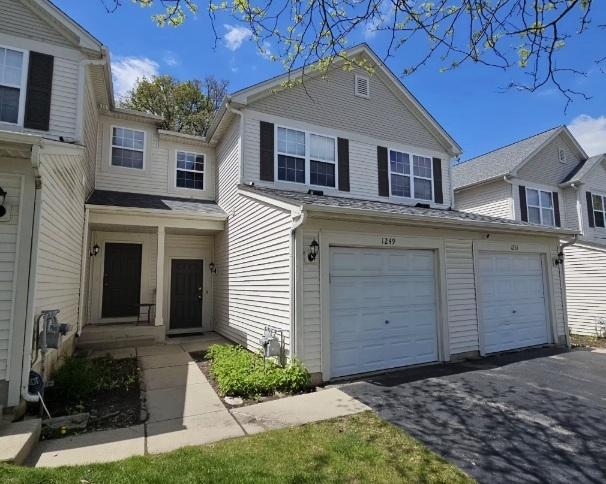 1249 Brookdale Dr Unit 1249, Carpentersville, IL 60110 - townhome / multi-family property with an attached garage and driveway