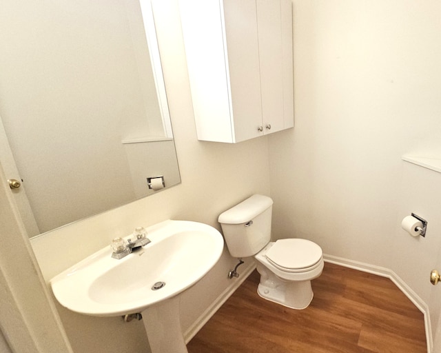 1249 Brookdale Dr Unit 1249, Carpentersville, IL 60110 - half bathroom with a sink, wood finished floors, toilet, and baseboards