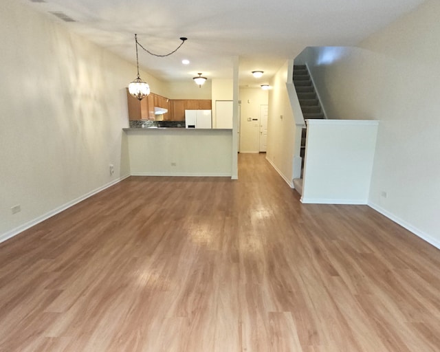1249 Brookdale Dr Unit 1249, Carpentersville, IL 60110 - unfurnished living room with stairs, wood finished floors, and baseboards