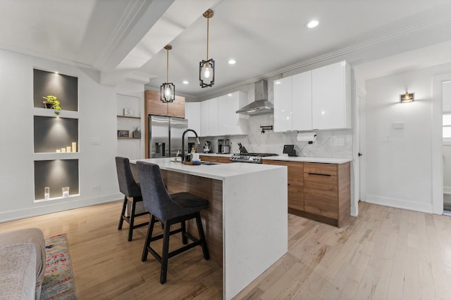 2705 Cuyler Ave, Berwyn, IL 60402 - kitchen featuring wall chimney range hood, stainless steel appliances, a sink, crown molding, and light wood-type flooring