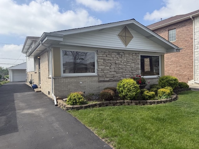 8325 W Maple Ave, Norridge, IL 60706 - view of front of property featuring an outdoor structure, a garage, brick siding, and a front lawn