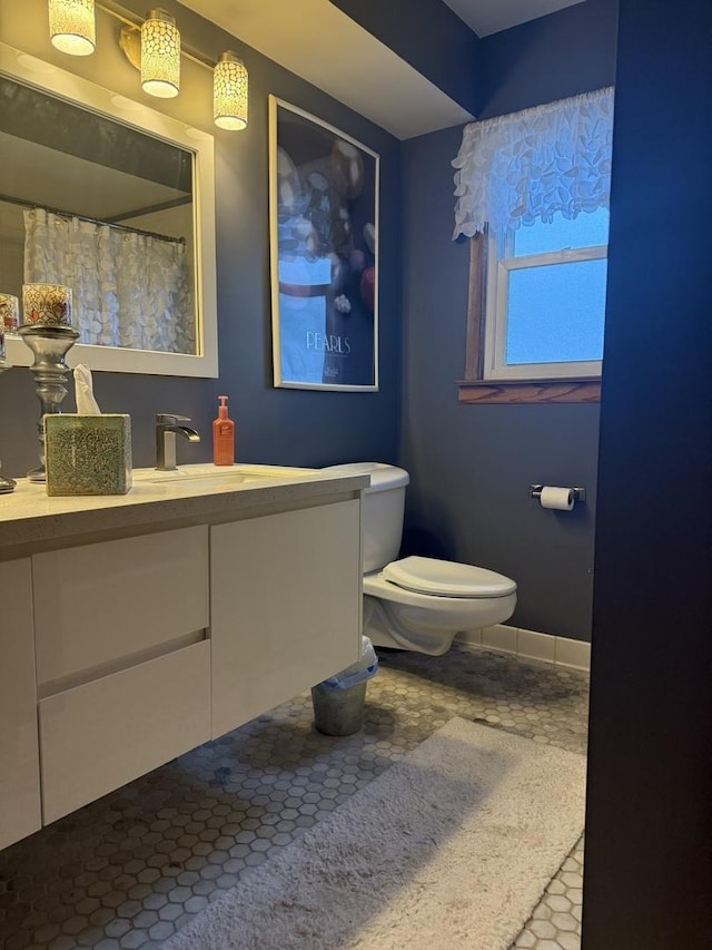 8325 W Maple Ave, Norridge, IL 60706 - bathroom with toilet, vanity, a shower with shower curtain, and baseboards