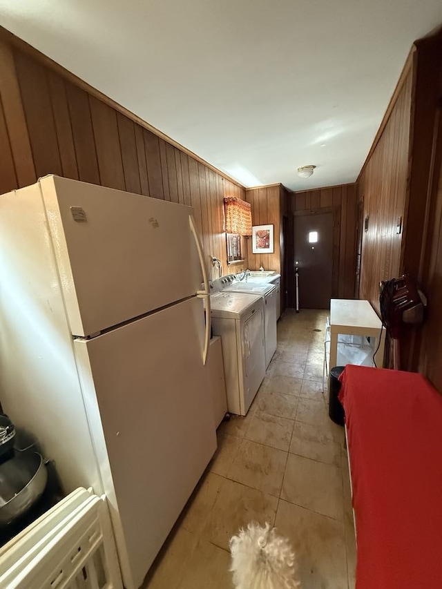8325 W Maple Ave, Norridge, IL 60706 - kitchen with freestanding refrigerator, wooden walls, washing machine and dryer, light countertops, and brown cabinetry