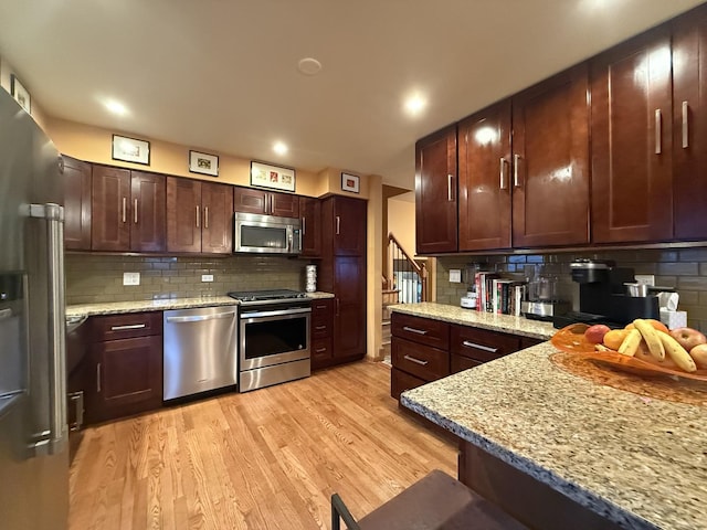 8325 W Maple Ave, Norridge, IL 60706 - kitchen with stainless steel appliances, tasteful backsplash, light wood finished floors, light stone countertops, and recessed lighting