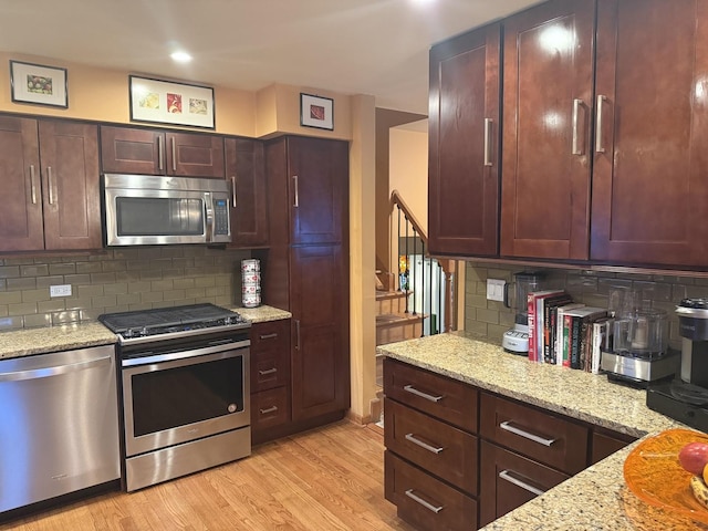 8325 W Maple Ave, Norridge, IL 60706 - kitchen with appliances with stainless steel finishes, backsplash, light wood-type flooring, light stone countertops, and recessed lighting