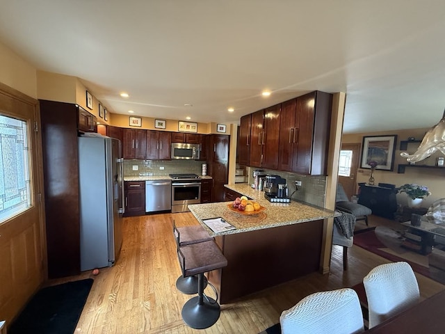 8325 W Maple Ave, Norridge, IL 60706 - kitchen with stainless steel appliances, a peninsula, tasteful backsplash, light wood finished floors, and recessed lighting