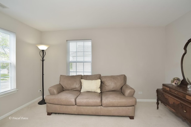 2402 Claremont Ln, Lake In The Hills, IL 60156 - living area with light carpet, healthy amount of natural light, and baseboards