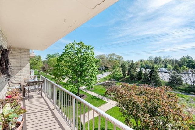 balcony featuring view of scattered trees