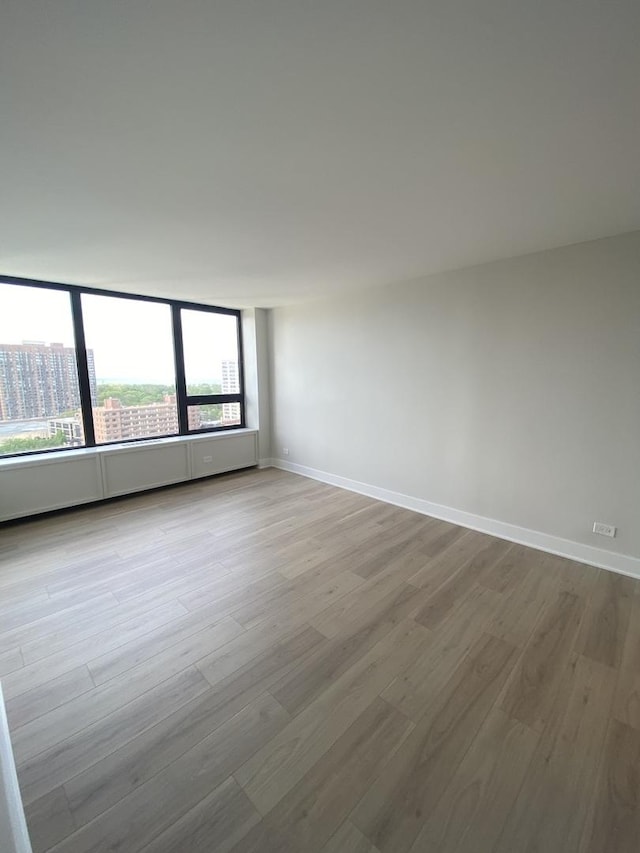 3930 N Pine Grove Ave Unit 1703, Chicago, IL 60613 - spare room featuring wood finished floors and baseboards