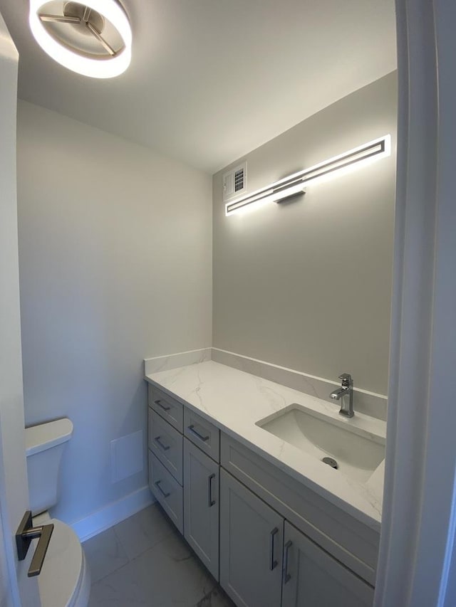 3930 N Pine Grove Ave Unit 1703, Chicago, IL 60613 - half bath with marble look tile flooring, toilet, vanity, and baseboards