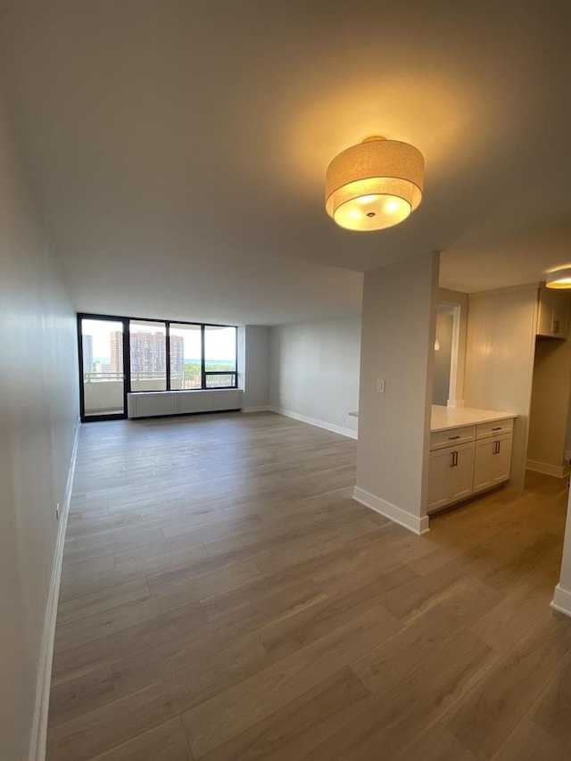 3930 N Pine Grove Ave Unit 1703, Chicago, IL 60613 - spare room featuring wood finished floors and baseboards