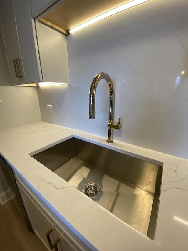 3930 N Pine Grove Ave Unit 1703, Chicago, IL 60613 - kitchen view of a sink, light stone countertops, and gray cabinets