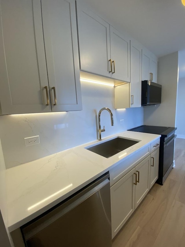 3930 N Pine Grove Ave Unit 1703, Chicago, IL 60613 - kitchen featuring a sink, electric range, stainless steel dishwasher, light wood-type flooring, and white cabinetry