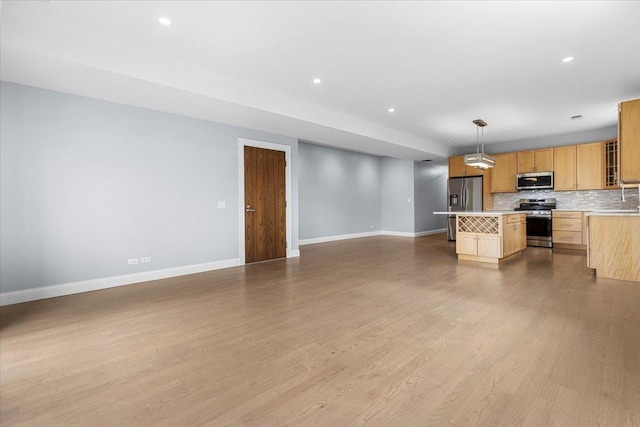 6436 N Lehigh Ave Unit 2N, Chicago, IL 60646 - kitchen with stainless steel appliances, open floor plan, baseboards, light countertops, and tasteful backsplash