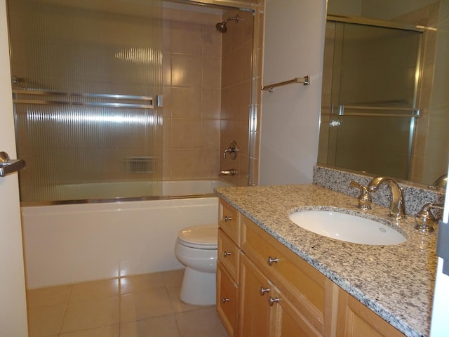 full bath with tile patterned floors, toilet, shower / bath combination with glass door, and vanity