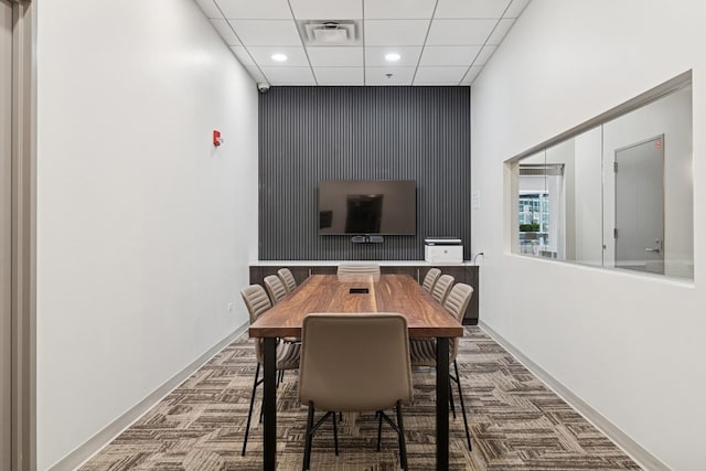 carpeted dining area featuring recessed lighting, a drop ceiling, and baseboards