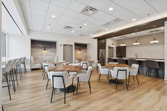 512 N Mcclurg Ct Unit 4904, Chicago, IL 60611 - dining space with light wood-type flooring, a paneled ceiling, and baseboards