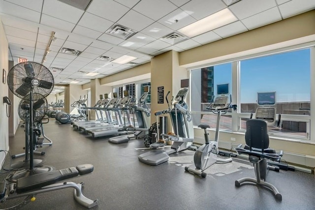 gym featuring plenty of natural light and a drop ceiling