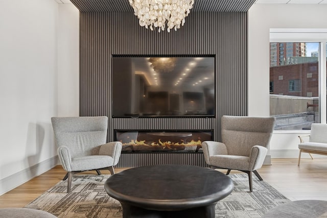 512 N Mcclurg Ct Unit 4904, Chicago, IL 60611 - living area with a glass covered fireplace, wood finished floors, baseboards, and a chandelier