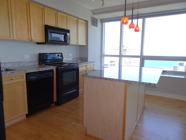 512 N Mcclurg Ct Unit 4904, Chicago, IL 60611 - kitchen with black appliances, light brown cabinets, light wood-style flooring, and pendant lighting