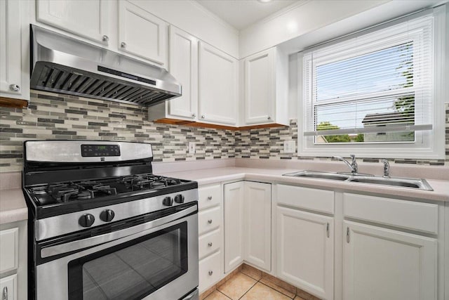 408 Lake Shore Cir, Bloomington, IL 61704 - kitchen featuring stainless steel gas range oven, under cabinet range hood, a sink, white cabinetry, and light countertops