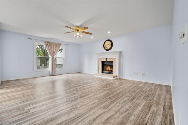 408 Lake Shore Cir, Bloomington, IL 61704 - unfurnished living room with wood finished floors, a ceiling fan, a high end fireplace, recessed lighting, and baseboards