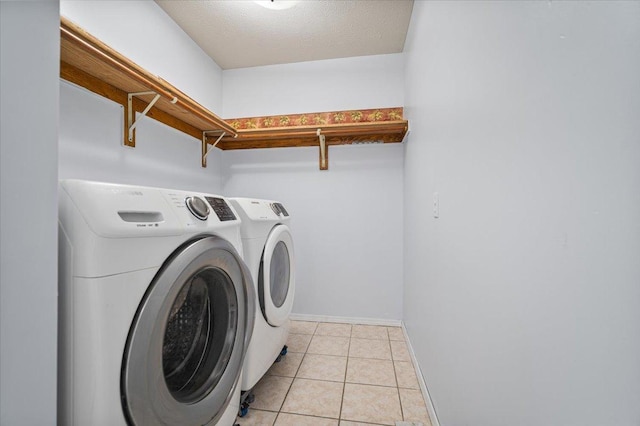 408 Lake Shore Cir, Bloomington, IL 61704 - washroom featuring washing machine and dryer, baseboards, and light tile patterned floors