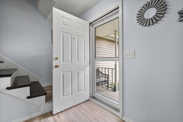 408 Lake Shore Cir, Bloomington, IL 61704 - entryway with light wood-type flooring, healthy amount of natural light, baseboards, and stairs