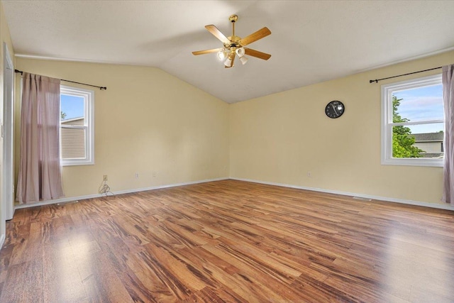 408 Lake Shore Cir, Bloomington, IL 61704 - unfurnished room featuring wood finished floors, vaulted ceiling, a ceiling fan, and baseboards
