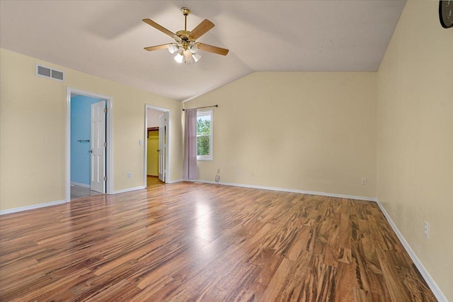 408 Lake Shore Cir, Bloomington, IL 61704 - unfurnished room featuring a ceiling fan, wood finished floors, vaulted ceiling, and baseboards
