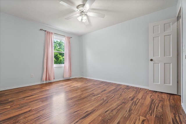 408 Lake Shore Cir, Bloomington, IL 61704 - empty room featuring wood finished floors, a ceiling fan, and baseboards