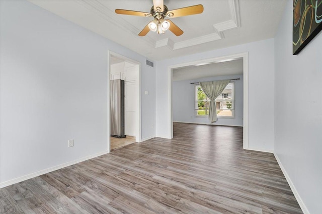 408 Lake Shore Cir, Bloomington, IL 61704 - empty room featuring a raised ceiling, wood finished floors, a ceiling fan, baseboards, and crown molding