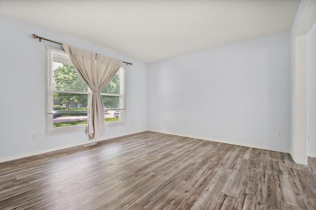 408 Lake Shore Cir, Bloomington, IL 61704 - unfurnished room with wood finished floors and baseboards