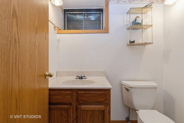 bathroom with toilet and vanity