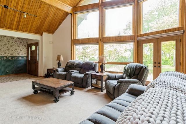 living room with high vaulted ceiling, wooden ceiling, plenty of natural light, beamed ceiling, and carpet flooring