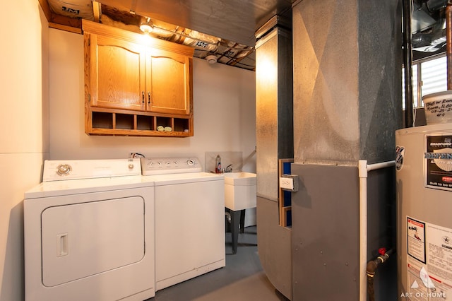 laundry room with cabinet space, washing machine and dryer, gas water heater, and heating unit