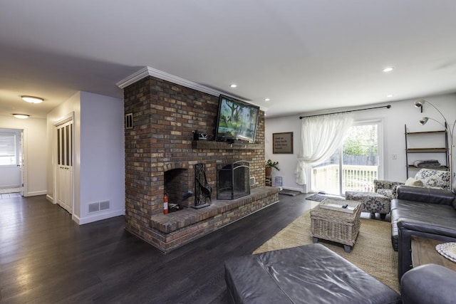 living room featuring healthy amount of natural light, a brick fireplace, wood finished floors, and recessed lighting
